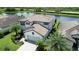 Two-story house with tile roof, driveway, and landscaping near lake at 17006 Blue Ridge Pl, Lakewood Ranch, FL 34211