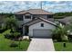 Two-story house with light gray siding, brown roof, and a paved driveway at 17006 Blue Ridge Pl, Lakewood Ranch, FL 34211