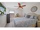 Bedroom with a queen bed, ceiling fan, and a view of the pool at 17006 Blue Ridge Pl, Lakewood Ranch, FL 34211