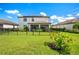 Two story home with fenced backyard, covered patio, and solar panels at 17006 Blue Ridge Pl, Lakewood Ranch, FL 34211