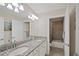 Double vanity bathroom with granite countertop and a large mirror at 17006 Blue Ridge Pl, Lakewood Ranch, FL 34211