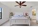 Bright bedroom with a queen-size bed, ceiling fan, and access to the bathroom at 17006 Blue Ridge Pl, Lakewood Ranch, FL 34211