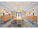 Elegant dining room with a large table, modern light fixtures, and built-in cabinets at 50 Central Ave # 17Phb, Sarasota, FL 34236