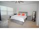 Spacious bedroom with large bed, dresser, and window coverings at 118 Veraza Ct, Nokomis, FL 34275