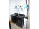 Convenient laundry room with washer, dryer, and storage shelves at 118 Veraza Ct, Nokomis, FL 34275