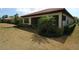 Landscaped backyard with covered patio and tropical plants at 118 Veraza Ct, Nokomis, FL 34275