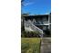 Front view of two-story condo with stairs and landscaping at 6033 34Th W St # 1, Bradenton, FL 34210
