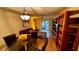 Open living and dining area with hardwood floors and glass table at 6033 34Th W St # 1, Bradenton, FL 34210