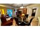 Open living and dining area with hardwood floors and glass table at 6033 34Th W St # 1, Bradenton, FL 34210