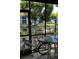 Enclosed patio with table, chairs, and view of the canal at 6033 34Th W St # 1, Bradenton, FL 34210