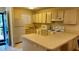 Galley kitchen with white appliances and ample counter space at 6033 34Th W St # 1, Bradenton, FL 34210