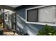 Exterior view of condo building with gray siding and landscaping at 6033 34Th W St # 1, Bradenton, FL 34210