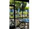 Enclosed patio with canal view, table, chairs and bicycle at 6033 34Th W St # 1, Bradenton, FL 34210