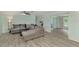 Spacious living room with grey sectional sofa and wood-look flooring at 2900 Siesta Dr, Venice, FL 34293
