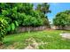 Backyard with lush green grass and a wooden fence at 2900 Siesta Dr, Venice, FL 34293