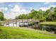 Wooden footbridge over tranquil water in a lush, green community at 12444 Destin Loop, Venice, FL 34293