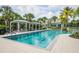 Community lap pool with striped cabanas at 12444 Destin Loop, Venice, FL 34293