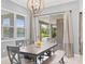 Bright dining room with wooden table and bench, offering a view of the backyard at 12444 Destin Loop, Venice, FL 34293
