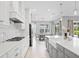 Spacious kitchen boasts white cabinets, quartz countertops, and stainless steel appliances at 12444 Destin Loop, Venice, FL 34293