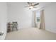 Bright bedroom with carpeted floors, a ceiling fan, and a window with curtains at 12444 Destin Loop, Venice, FL 34293