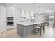 Modern kitchen with white cabinets, large island, and stainless steel appliances at 12444 Destin Loop, Venice, FL 34293