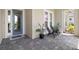 Inviting front porch with blue door and comfortable seating at 12444 Destin Loop, Venice, FL 34293