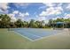 Well-maintained tennis court with shade structure at 12444 Destin Loop, Venice, FL 34293