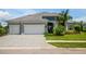 Two-story house with three-car garage and paver driveway at 12444 Destin Loop, Venice, FL 34293
