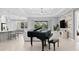 Spacious living room with a grand piano and open floor plan at 12444 Destin Loop, Venice, FL 34293