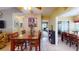 Bright dining area with glass-top table and access to other rooms at 461 Clover Rd, Venice, FL 34293