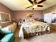 Bedroom with floral bedding and ceiling fan at 461 Clover Rd, Venice, FL 34293