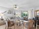Spacious living room with comfortable seating, a large window, and access to a screened patio at 6101 34Th W St # 16A, Bradenton, FL 34210