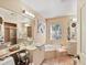 Spacious bathroom with double sinks, a bathtub, and a separate shower at 6101 34Th W St # 16A, Bradenton, FL 34210