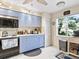 Bright kitchen features light blue cabinets, modern appliances, and a window overlooking a garden at 6101 34Th W St # 16A, Bradenton, FL 34210