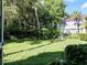 Landscaped backyard with lush greenery and a stone table at 6101 34Th W St # 16A, Bradenton, FL 34210