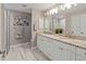 Elegant bathroom with double vanity and a large walk-in shower at 3800 Davis Blvd, Sarasota, FL 34232