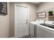 Laundry room with washer, dryer, and shelving at 3800 Davis Blvd, Sarasota, FL 34232