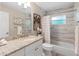 Updated bathroom with granite countertop and tile shower at 3800 Davis Blvd, Sarasota, FL 34232