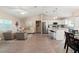 Open concept living room and kitchen with vaulted ceilings and wood-look floors at 3800 Davis Blvd, Sarasota, FL 34232