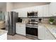 Modern kitchen with stainless steel appliances and granite countertops at 3800 Davis Blvd, Sarasota, FL 34232
