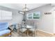 Bright dining area with glass-top table and four chairs at 1023 Roberta St, Venice, FL 34285