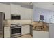 Updated kitchen with white cabinets, granite counters, and stainless steel appliances at 2715 Terra Ceia Bay Blvd # 702, Palmetto, FL 34221