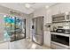 Modern kitchen with stainless steel appliances and patio access at 3124 Windrush Bourne # 10, Sarasota, FL 34235