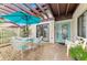 Relaxing patio with seating area, umbrella, and grill at 3124 Windrush Bourne # 10, Sarasota, FL 34235
