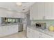 Modern kitchen featuring white cabinets, granite countertops, and stainless steel appliances at 3124 Windrush Bourne # 10, Sarasota, FL 34235
