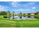 Community features lakefront views and lush landscaping at 3124 Windrush Bourne # 10, Sarasota, FL 34235