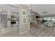 Open living room with vaulted ceiling, fireplace, and view to lanai at 3124 Windrush Bourne # 10, Sarasota, FL 34235