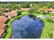 Aerial view of community with lake and pool at 3124 Windrush Bourne # 10, Sarasota, FL 34235
