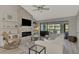 Living room with fireplace, water view, and comfy seating at 3124 Windrush Bourne # 10, Sarasota, FL 34235