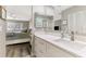 Bright bathroom with white cabinets, quartz countertop, and a view of the bedroom at 3124 Windrush Bourne # 10, Sarasota, FL 34235